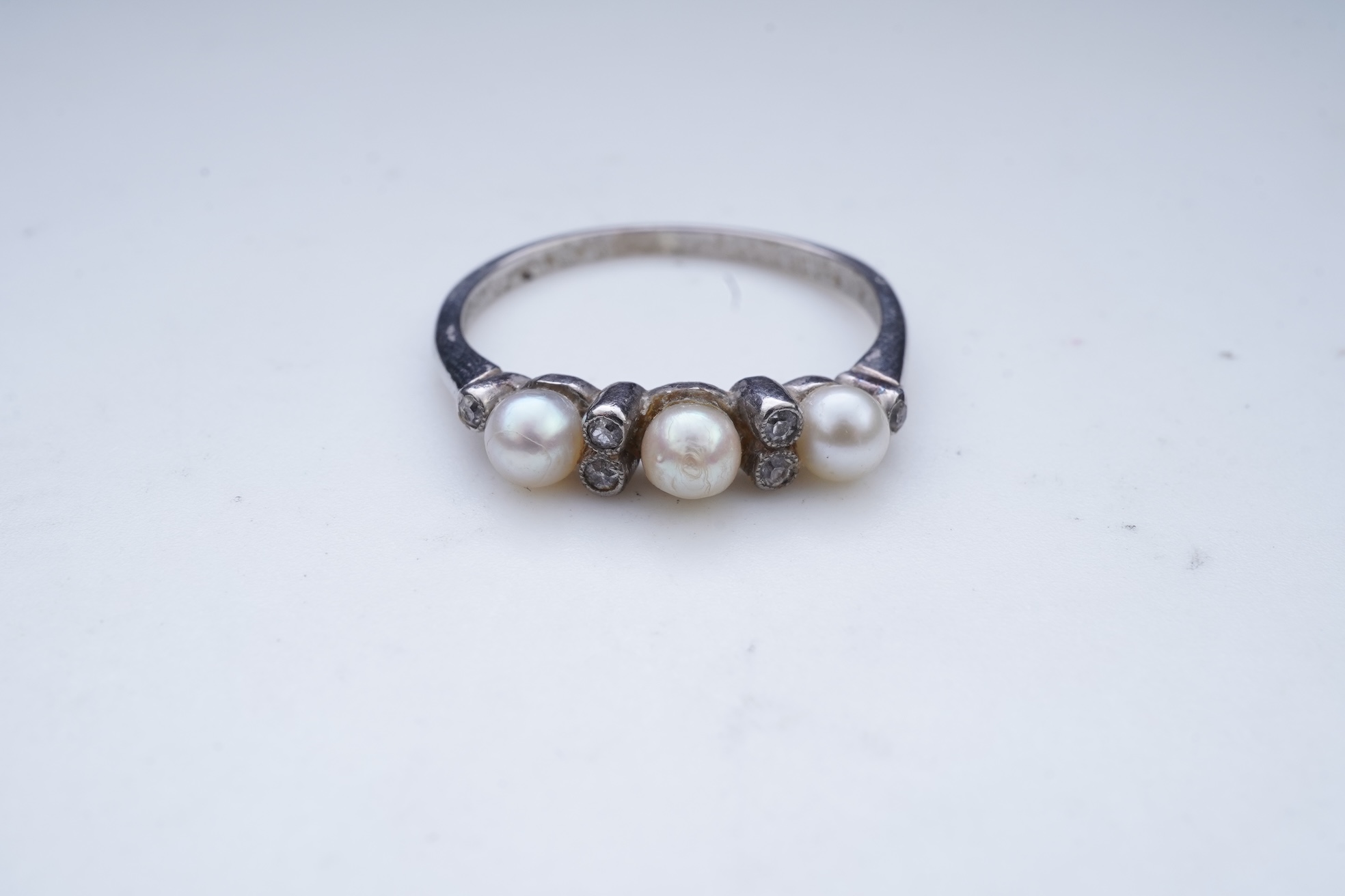 An Edwardian seed pearl brooch and a pearl and diamond ring